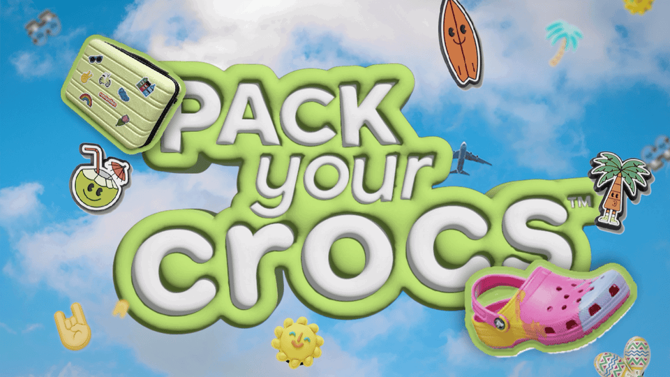 Pack your Crocs campaign artwork with a pink Croc, suitcase and holiday charms